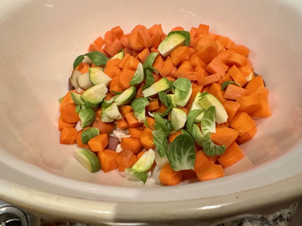 the filling of this shepherd's pie is unique, starting with carrots and brussels sprouts