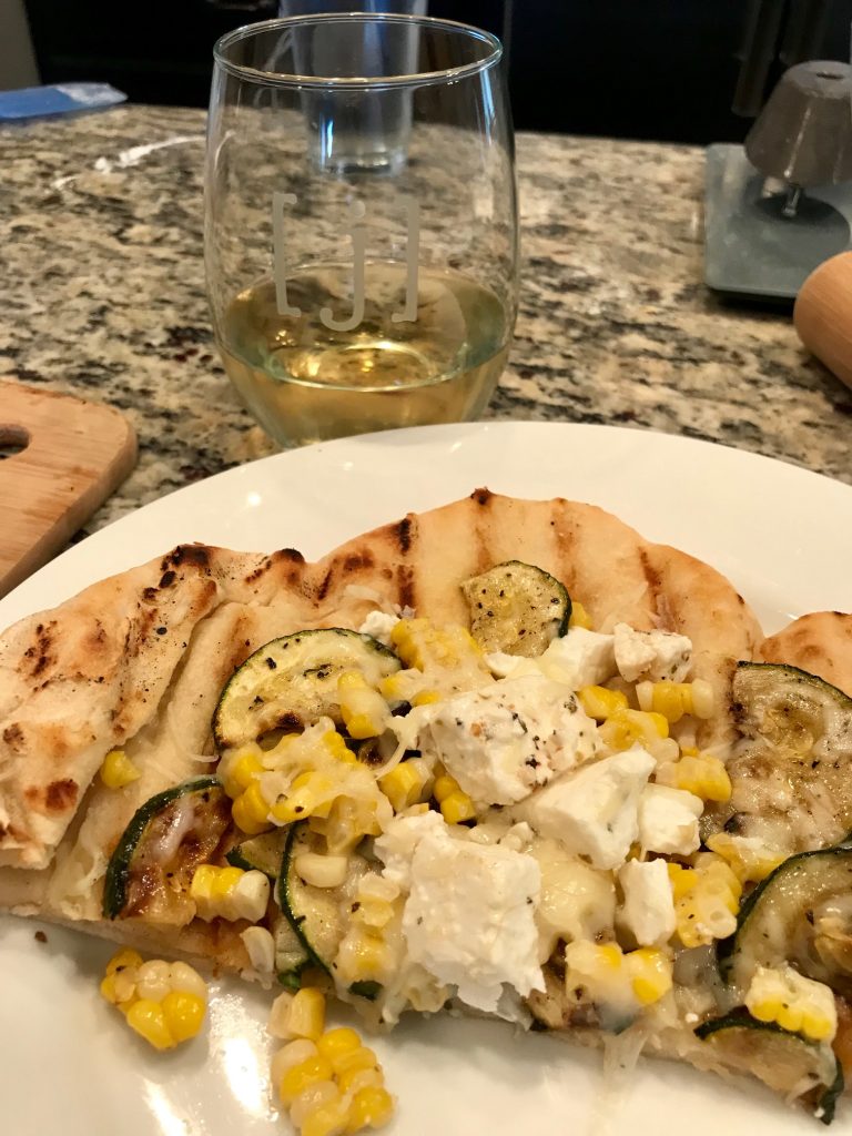 Grilled Pizza with Zucchini, Corn, & Marinated Feta | This grilled zucchini pizza is perfect for summer, delicious and easy. Grilled corn and salty marinated feta add to the flavors, along with an easy chewy homemade pizza crust. Perfect grilling recipe. #grilling #grilledpizza #summerrecipes 