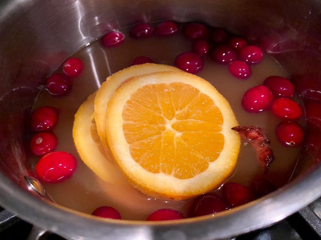 Spiked Apple Cider with Port & Cranberries - Simmering apple cider, cranberries, star anise, cinnamon, oranges, & port