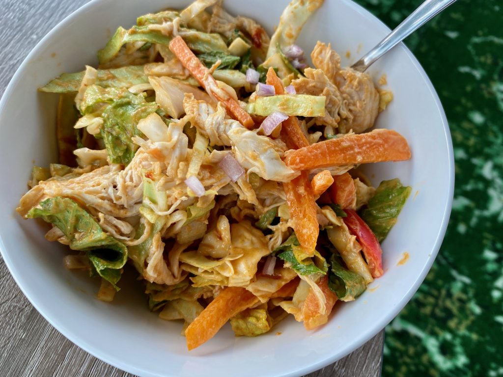 Easy & Healthy "Loaded" Thai Chicken Salad | This Thai cabbage salad is super easy to make, loaded with veggies & has a flavorful sweet-spicy-savory dressing that makes it a pleasure to eat! This healthy meal only takes 15 minutes to make & is a perfect easy weeknight meal. #chicken #healthydinner #healthyrecipe #cabbage 
