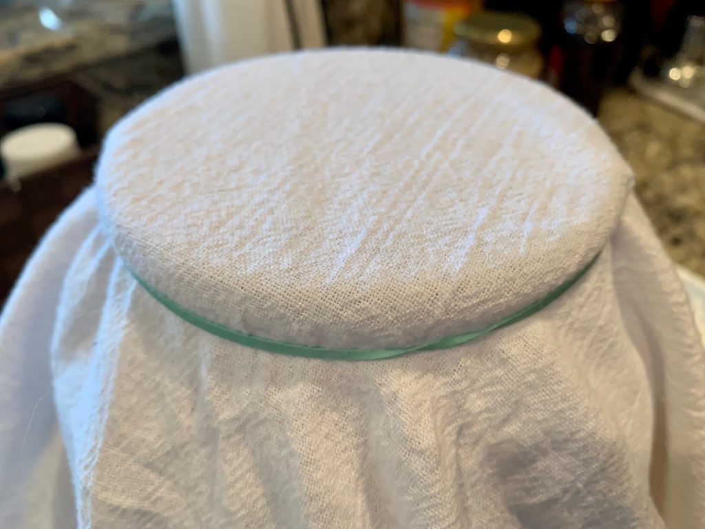 You cover your homemade kombucha with a flour sack towel while it's brewing, not a lid