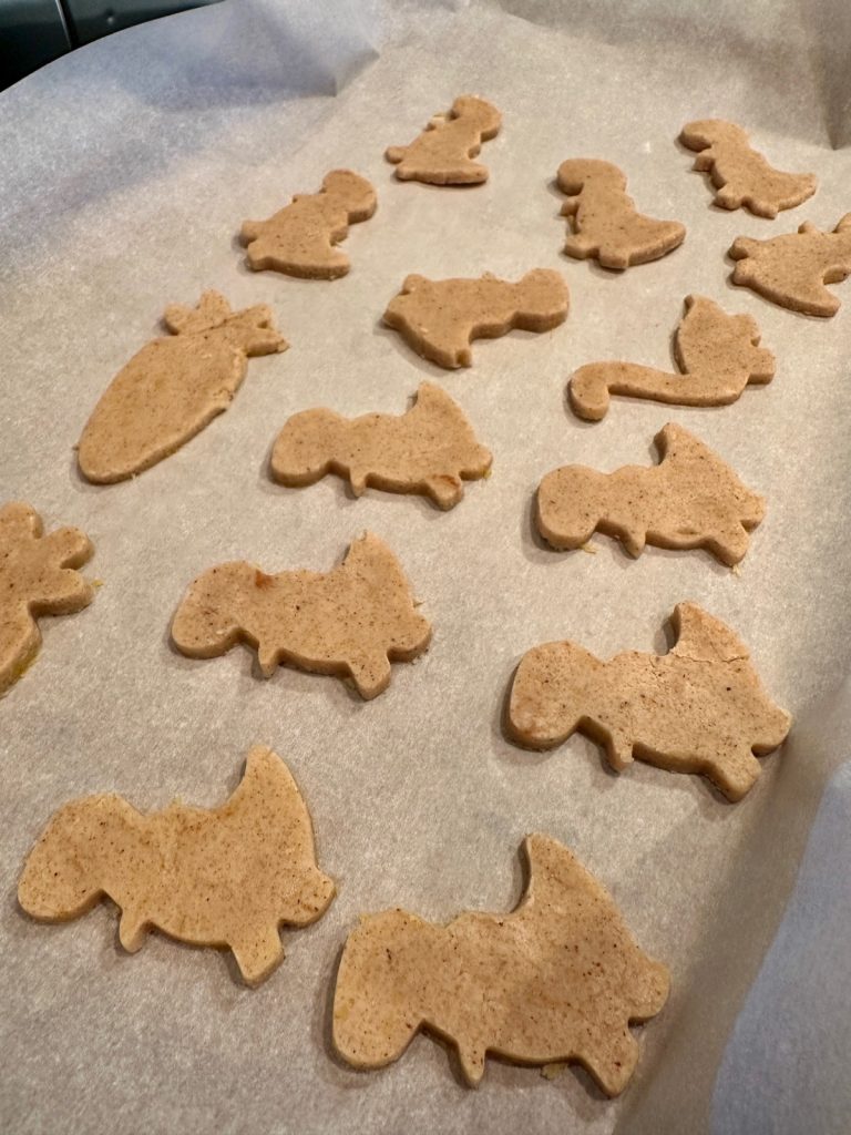 cutting out chai spiced shortbread cookies in fun shapes