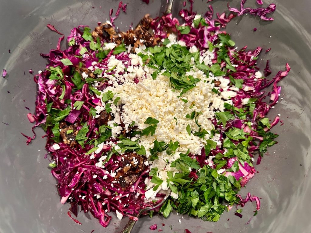assembling the red cabbage, feta, & date salad slaw