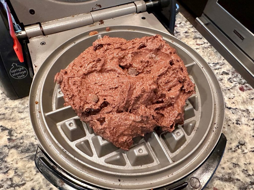 gluten-free chocolate waffle batter in the waffle maker
