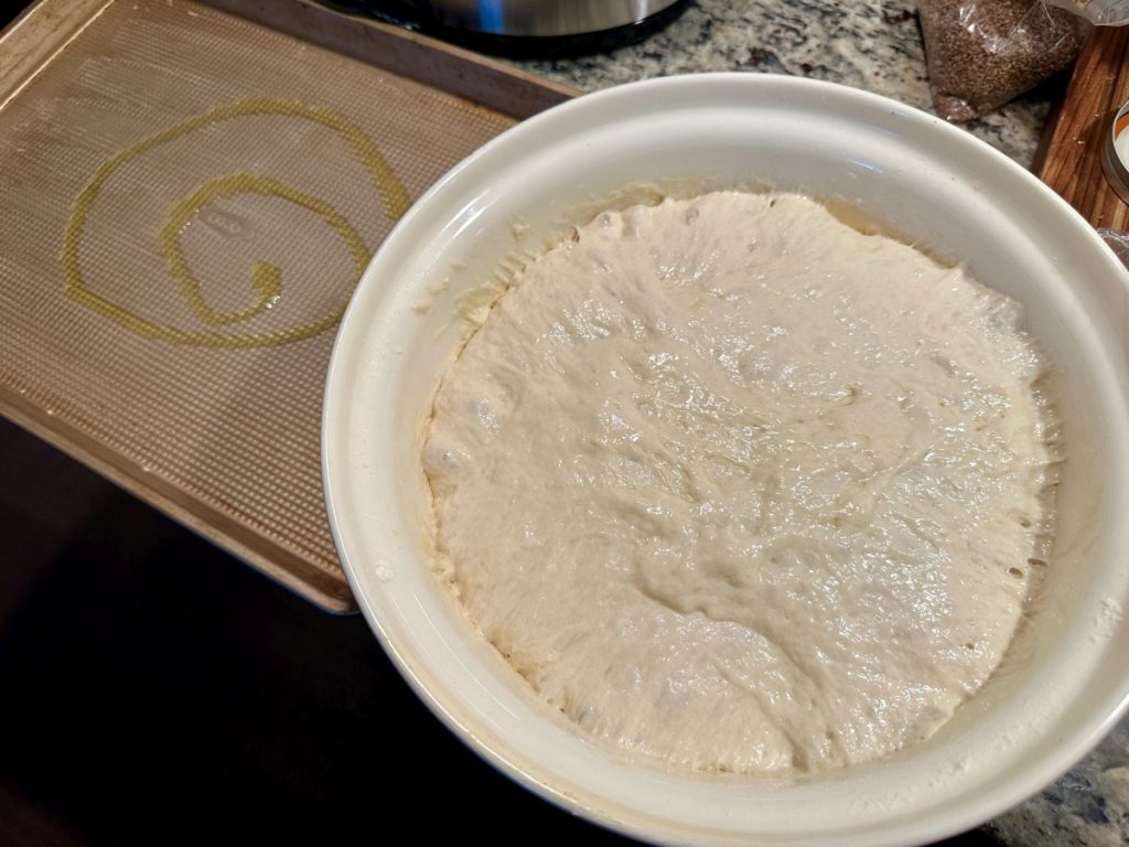 risen focaccia dough ready to pour in the pan 