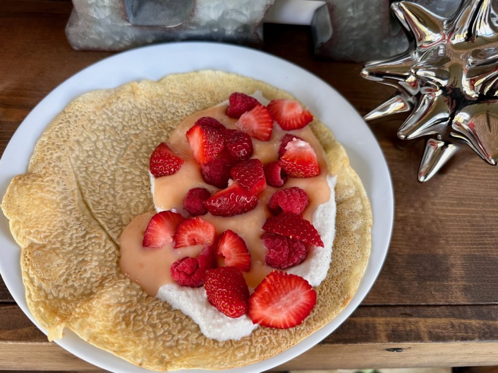 These spiced crepes are a deliciously elevated (and incredibly easy) version of the classic, taking only a few minutes to throw together. We top them with a tart grapefruit curd and a spiced whipped ricotta along with fresh strawberries. It is light-yet-decadent, and perfect for a make-ahead brunch and also naturally unleavened so perfect for Passover!
