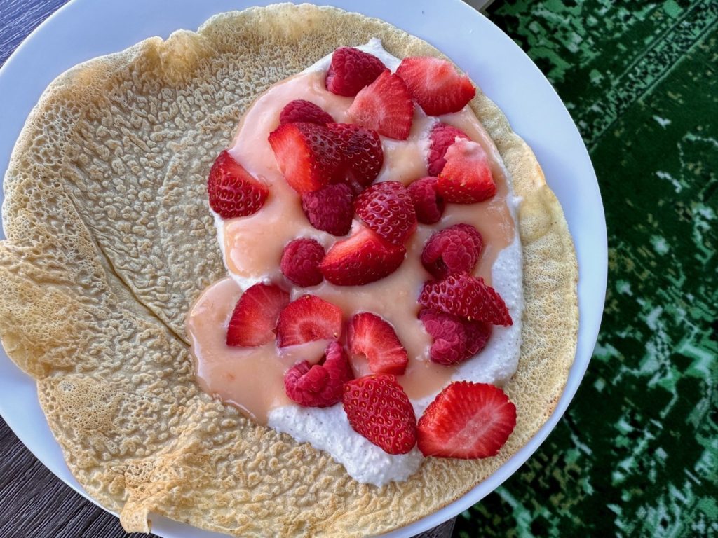 Spiced Crepes with Grapefruit Curd & Whipped Ricotta | These spiced crepes are a deliciously elevated (and incredibly easy) version of the classic, taking only a few minutes to throw together. We top them with a tart grapefruit curd and a spiced whipped ricotta along with fresh strawberries. It is light-yet-decadent, and perfect for a make-ahead brunch and also naturally unleavened so perfect for Passover!