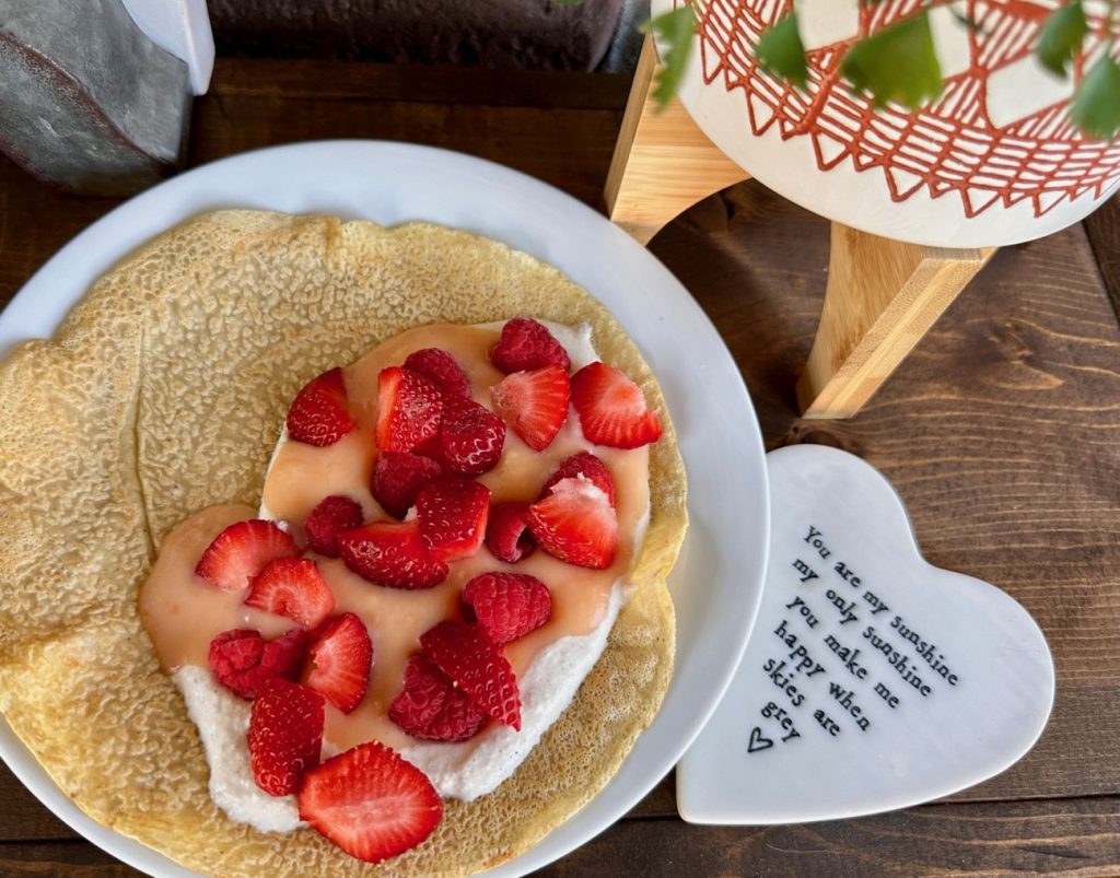 Spiced Crepes with Grapefruit Curd & Whipped Ricotta | These spiced crepes are a deliciously elevated (and incredibly easy) version of the classic, taking only a few minutes to throw together. We top them with a tart grapefruit curd and a spiced whipped ricotta along with fresh strawberries. It is light-yet-decadent, and perfect for a make-ahead brunch and also naturally unleavened so perfect for Passover!