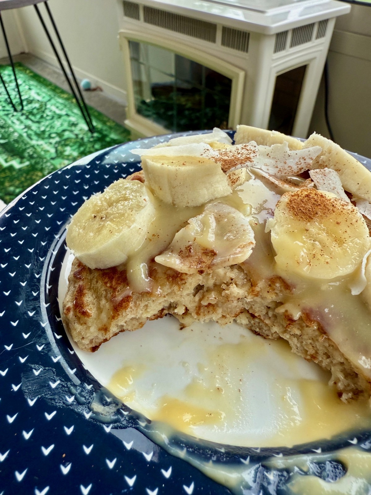 These lightly-spiced coconut banana pancakes have a delightful tiki vibe, with subtle tropical flavors of coconut and banana that you can take over the top with some extra banana and pineapple topping!  