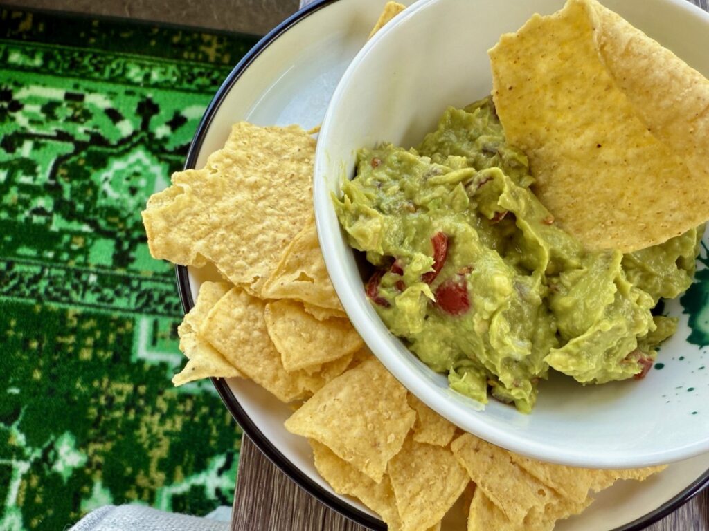 How to Make the Best Guacamole | Guac is pure comfort food, perfect alone with chips, or piled on top of delicious Tex-Mex food. This has been my go-to recipe for years, IMO the best guacamole recipe! I'm not a purist (just avocado) and I don't use jalapeno, but I do add some red onion & tomato plus seasonings for a flavor punch.