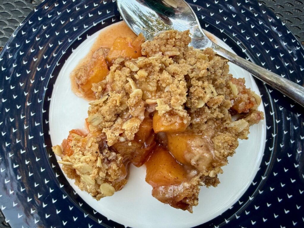 The Perfect Peach Crisp | This brown butter bourbon peach crisp is the ultimate version of this American classic, and a pure summer treat! All you need are delicious ripe peaches and only a few minutes of hands-on time. The is the best peach crisp out there.