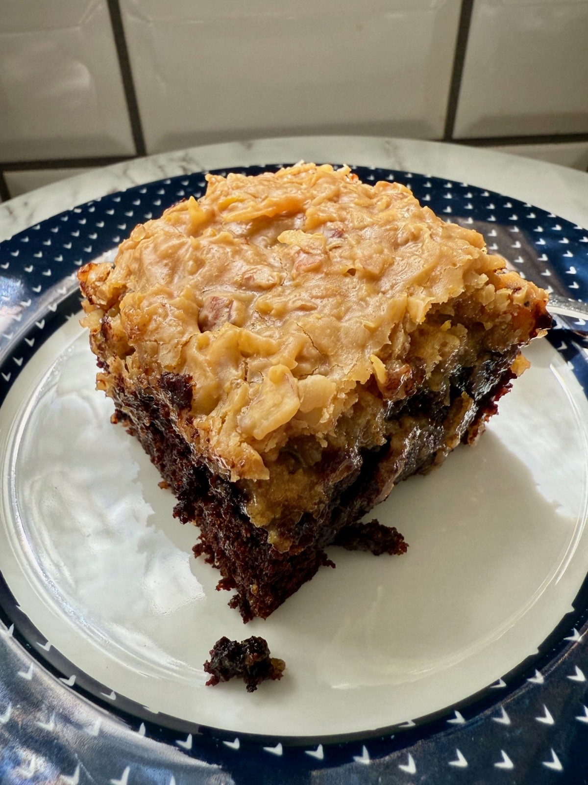 How to Make German Chocolate Cake | You'll never go store-bought again!  This homemade German chocolate cake is insanely delicious and super easy to make.  Pair a rich, fudgy chocolate cake with the famous caramel pecan coconut frosting for a special treat that's perfect for any occasion.  This is the best German chocolate cake recipe, an iconic American dessert. #desserts #cakerecipe #chocolatecake 