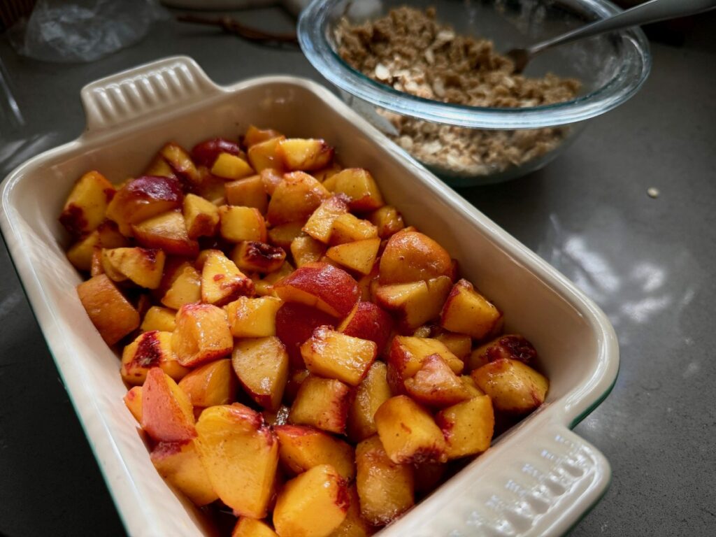 The Perfect Peach Crisp | This brown butter bourbon peach crisp is the ultimate version of this American classic, and a pure summer treat! All you need are delicious ripe peaches and only a few minutes of hands-on time. The is the best peach crisp out there.