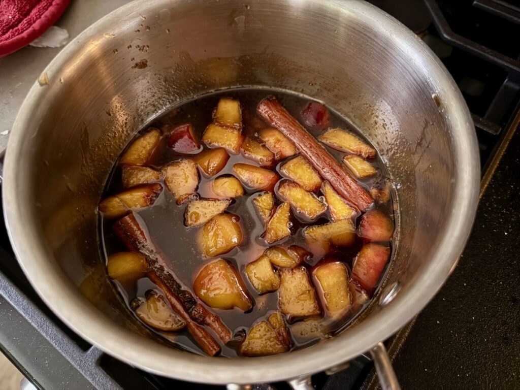 This spiced peach cobbler syrup is sweet and juicy, a perfect way to use summer peaches.  It's full of fruit and spices, and makes an amazing iced coffee or cocktails!  