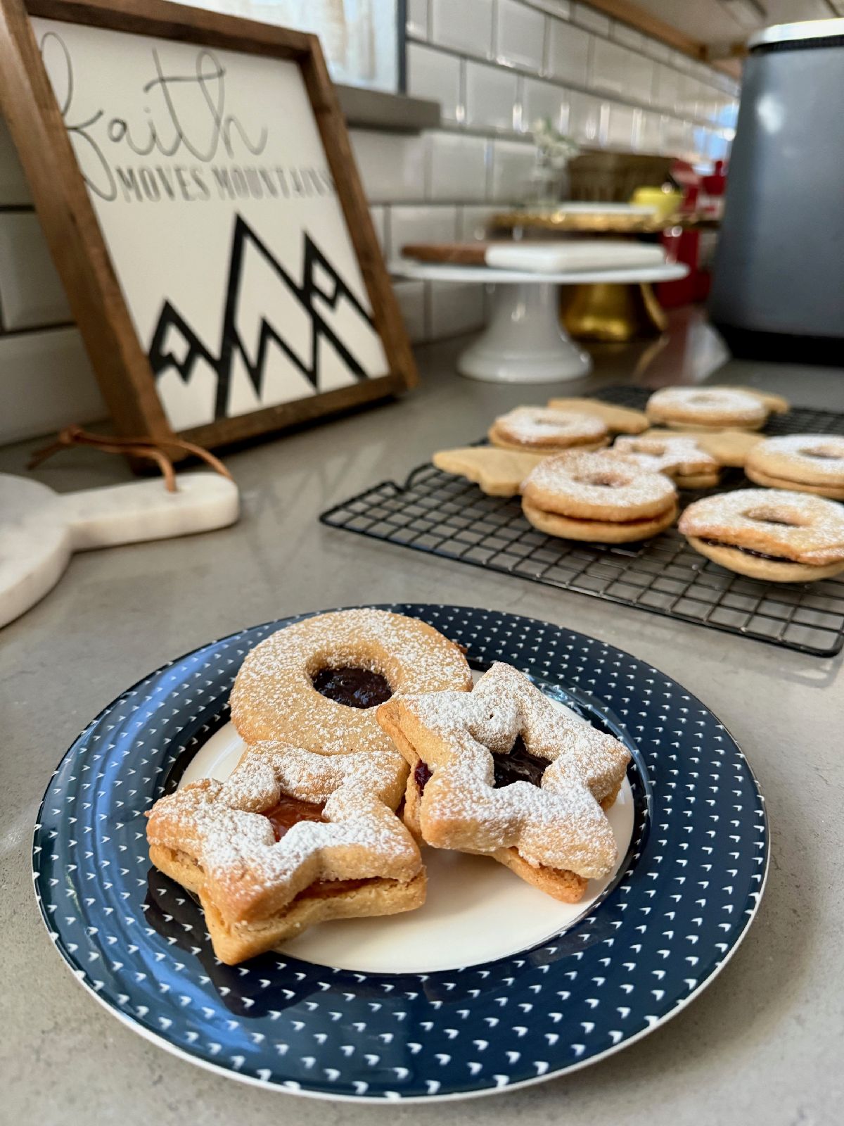 Hazelnut Linzer Cookies with Jam | These spiced hazelnut linzer cookies are mouthwateringly good, and shockingly easy to make. The warmly spiced buttery cookies are filled with a tart jam for the perfect cozy snack! This is one cookie recipe you'll want to have in your arsenal any time of year, a perfect holiday cookie recipe, cozy winter cookie recipe, and pretty cookies for a shower or Mother's Day brunch.