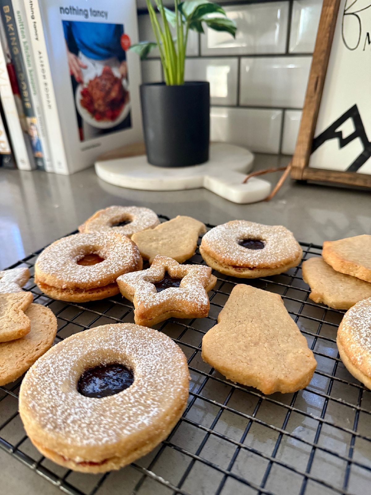 Hazelnut Linzer Cookies with Jam | These spiced hazelnut linzer cookies are mouthwateringly good, and shockingly easy to make. The warmly spiced buttery cookies are filled with a tart jam for the perfect cozy snack! This is one cookie recipe you'll want to have in your arsenal any time of year, a perfect holiday cookie recipe, cozy winter cookie recipe, and pretty cookies for a shower or Mother's Day brunch.