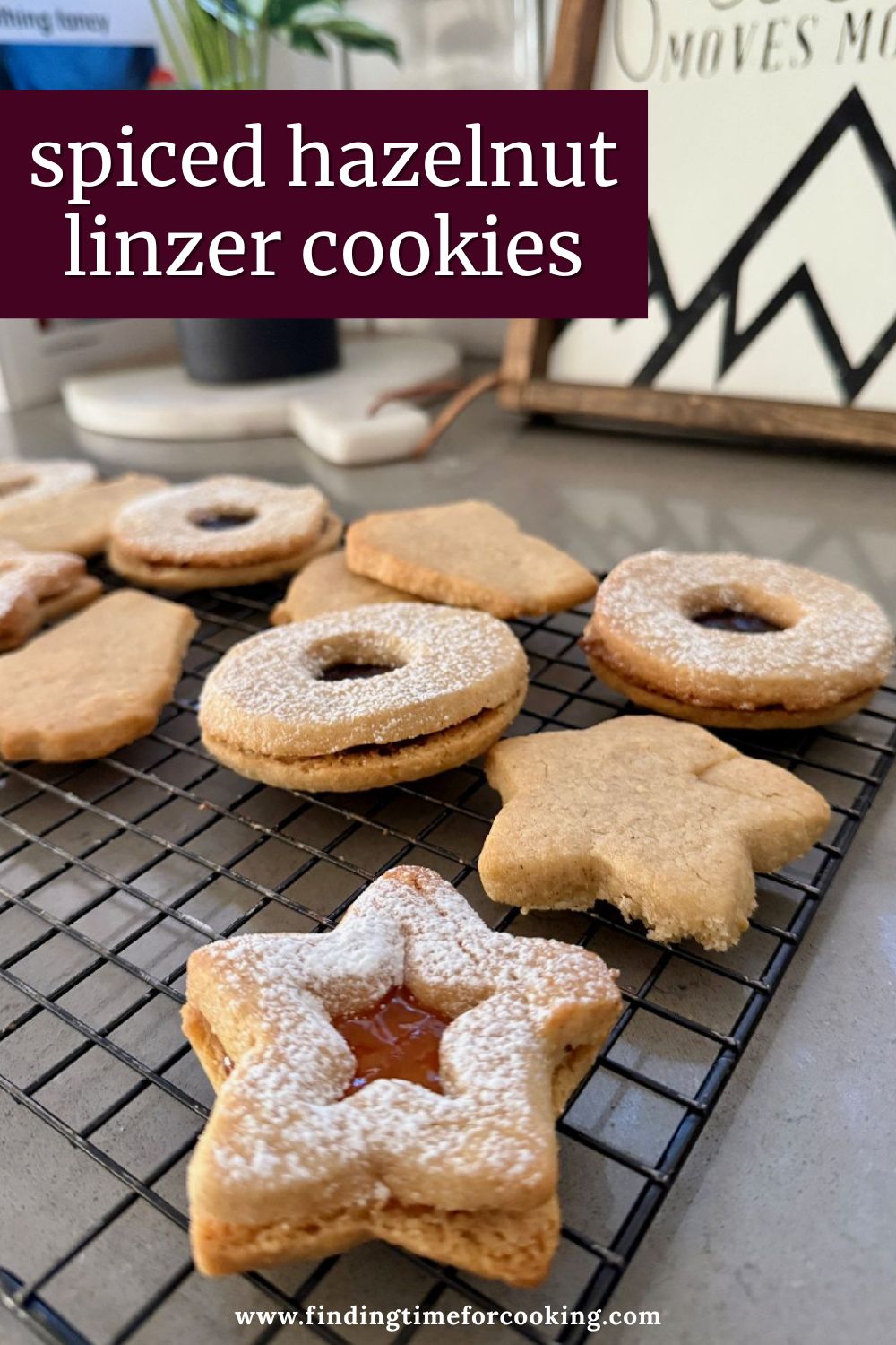 Hazelnut Linzer Cookies with Jam | These spiced hazelnut linzer cookies are mouthwateringly good, and shockingly easy to make. The warmly spiced buttery cookies are filled with a tart jam for the perfect cozy snack! This is one cookie recipe you'll want to have in your arsenal any time of year, a perfect holiday cookie recipe, cozy winter cookie recipe, and pretty cookies for a shower or Mother's Day brunch.