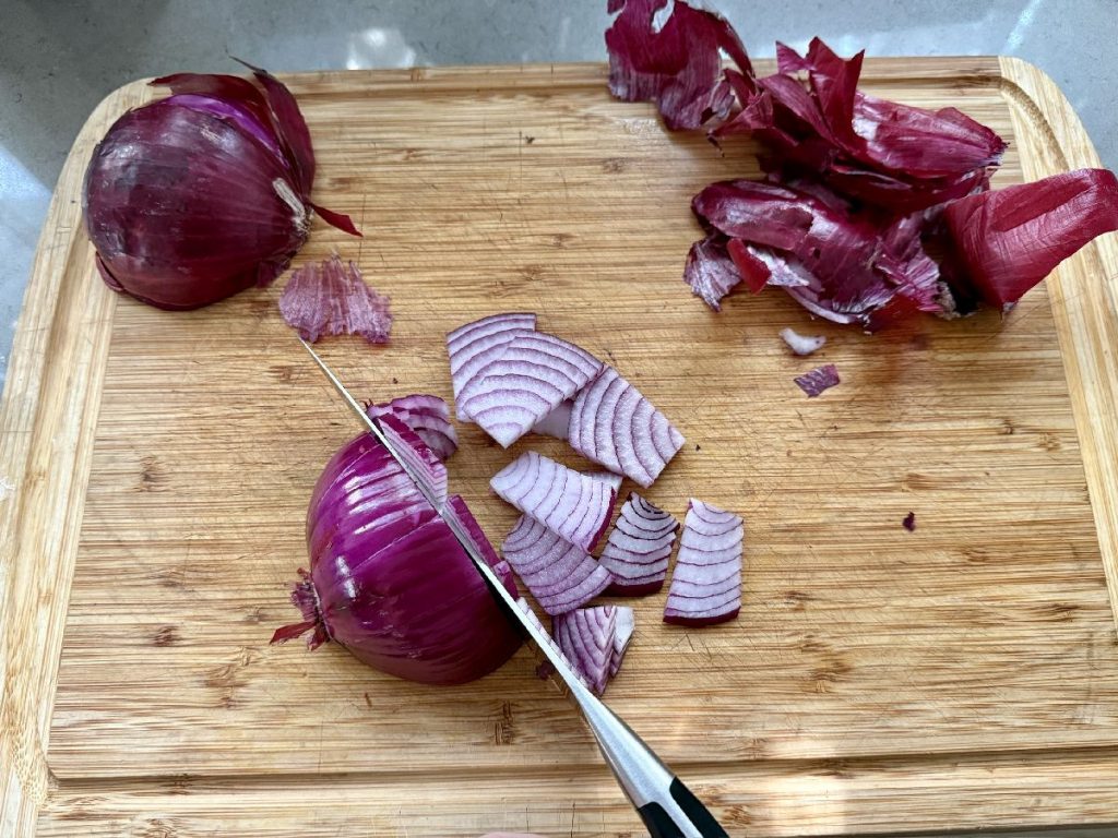 thinly slicing red onions to pickle them